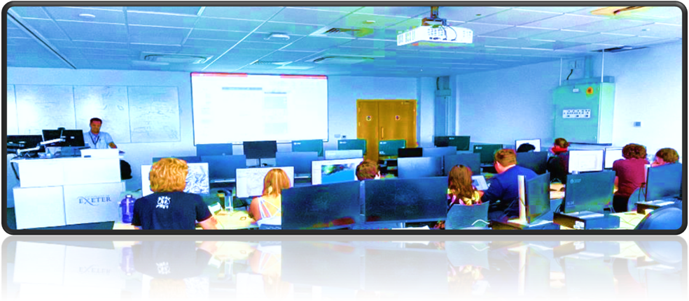 A group of people in a room with computers

Description automatically generated